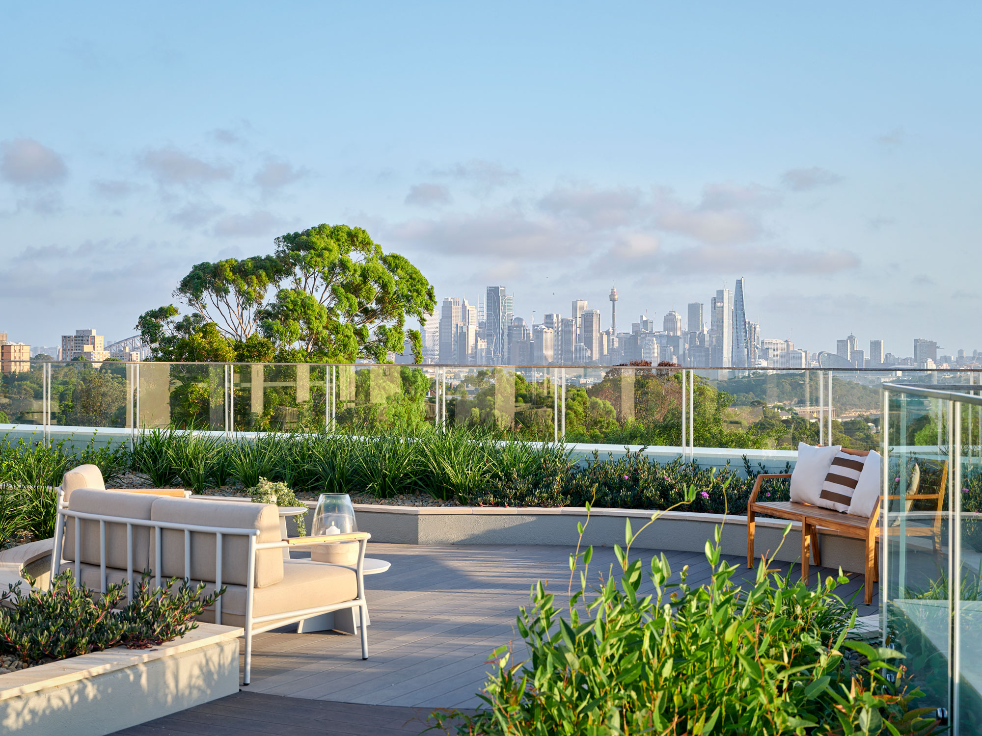 Rooftop Club and Bar outdoor seating with view of Sydney cbd, harbour and bridge in the background