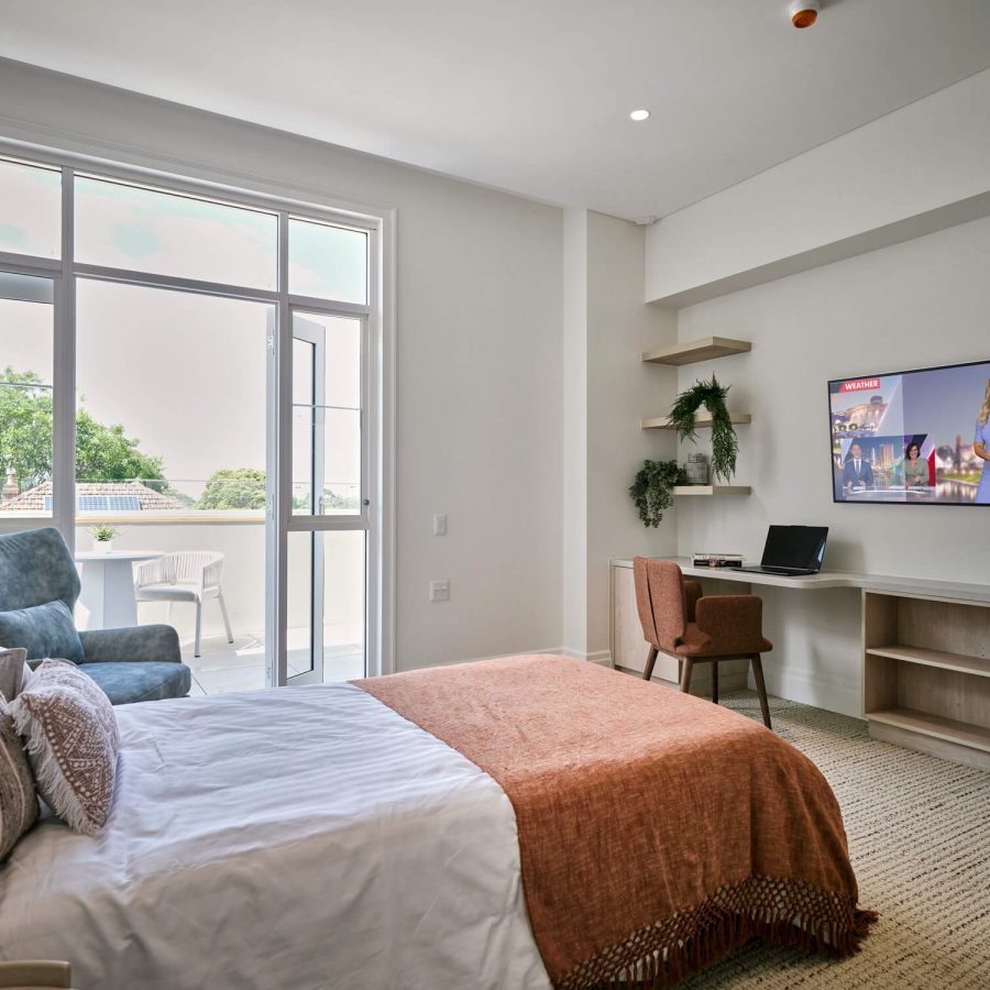 Greenwich Place Deluxe bed, open terrace doors and desk with television