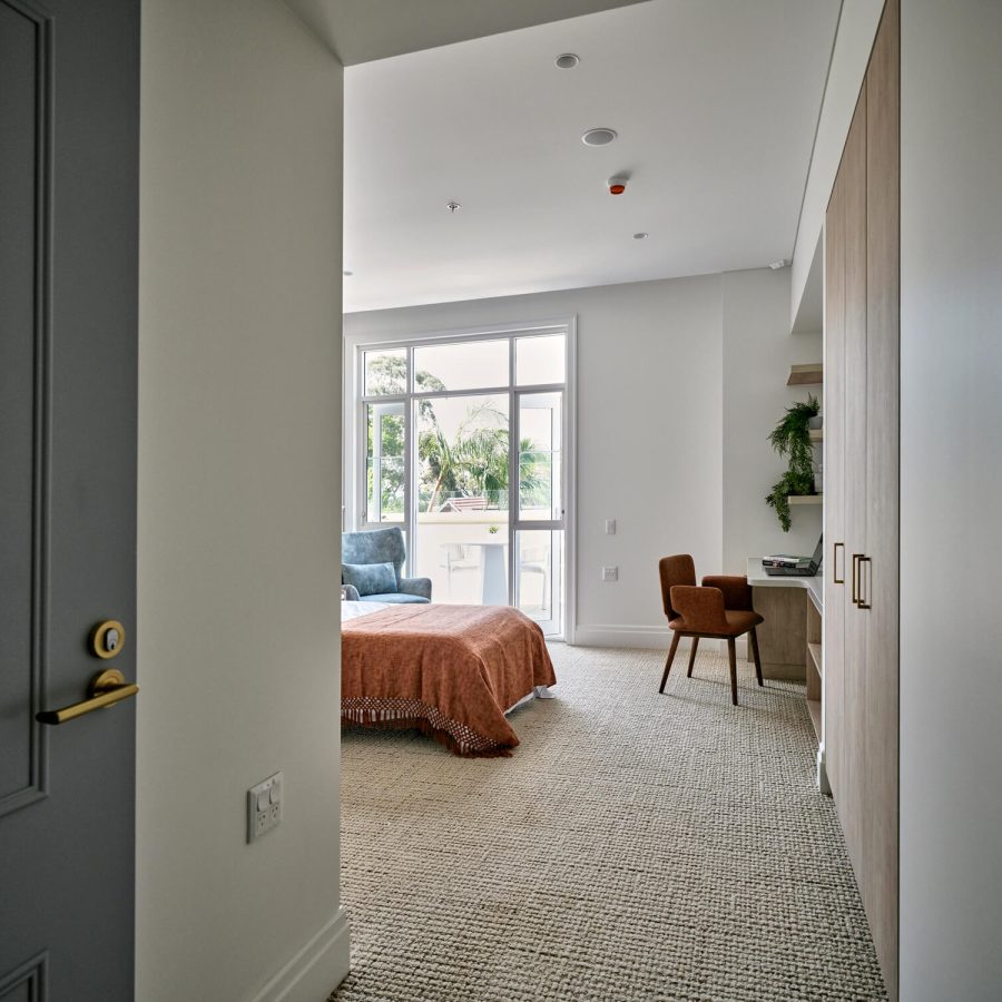 Greenwich Place Deluxe view from the front door with bed, terrace and desk in view